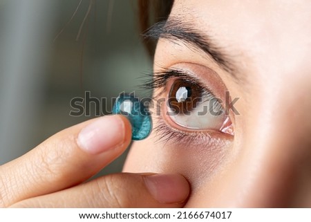 Close up Young asian woman with contact lens. Medicine and vision concept Royalty-Free Stock Photo #2166674017