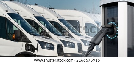 Electric vehicles charging station on a background of a row of vans. Concept Royalty-Free Stock Photo #2166675915