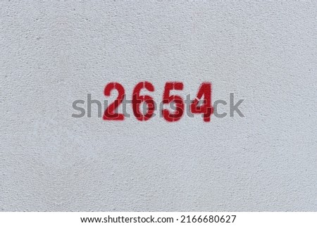 Red Number 2654 on the white wall. Spray paint.
