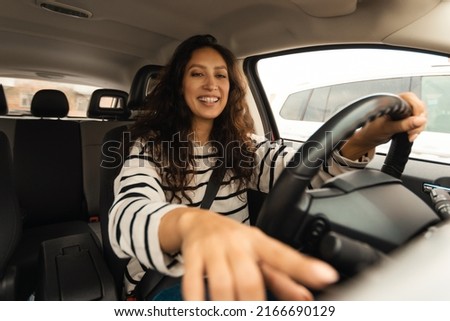 Arabic Driver Lady Driving Car Pushing Button Starting Engine Sitting In New Automobile. Young Female Enjoying Auto Trip Pressing Buttons On Control Panel. Vehicle Ownership Concept Royalty-Free Stock Photo #2166690129