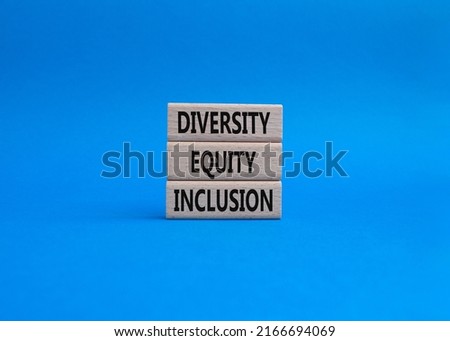 Diversity Equity Inclusion symbol. Concept words Diversity Equity Inclusion on wooden blocks. Beautiful blue background. Business and Diversity Equity Inclusion concept. Copy space. Conceptual image
