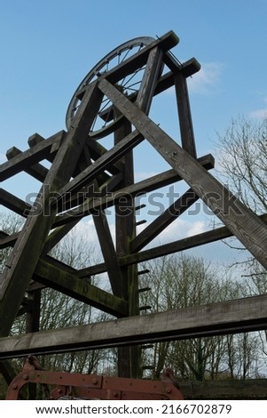 from below wooden mining rig and mining head wheel Royalty-Free Stock Photo #2166702879