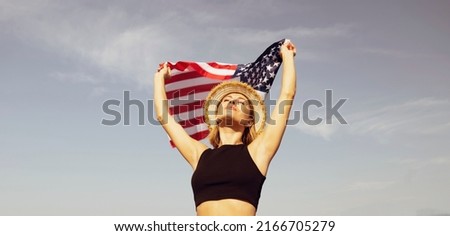 Bottom view of a young woman wearing a US flag hat. Flag day. American holiday. Beautiful woman in a black top