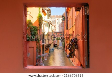 Secret window in the wall to the hidden part of the city in Bologna, Italy. Canal of Reno in Piella street Royalty-Free Stock Photo #2166706595