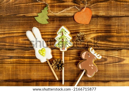 festive Christmas toys, treats and accessories on brown wooden background