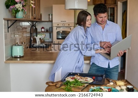 Couple making pizza together at home. Hobby, lifestyle.