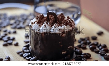 chocolate cake on wooden table with ice cube