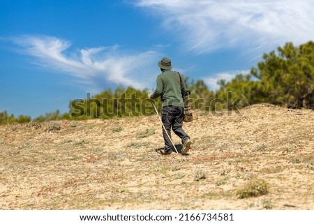 A nature photographer walking in nature