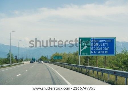 straight road with a sign of Kobuleti and Natanebi, Georgia. High quality photo