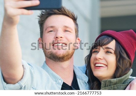 I can picture us side by side forever. Cropped shot of an affectionate young couple taking selfies together outdoors. Royalty-Free Stock Photo #2166777753
