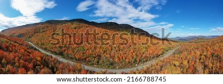 Peak fall foliage in Keene, New York by Cascade Lake. Royalty-Free Stock Photo #2166788745