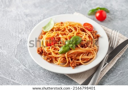 Pasta Spaghetti Bolognese in white plate on grey background. Bolognese sauce is classic italian cuisine dish. Popular italian food. Royalty-Free Stock Photo #2166798401