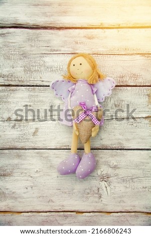 Cute angel with heart on old rustic wooden board - greeting card birthday and mothers day 