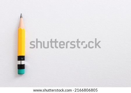Top view image of pencil over white textured paper