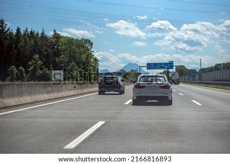 Traffic on Austrian autobahn on a summer day with an Alps background Royalty-Free Stock Photo #2166816893