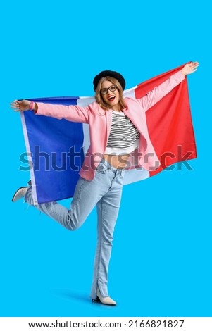 Beautiful happy young woman with flag of France on blue background