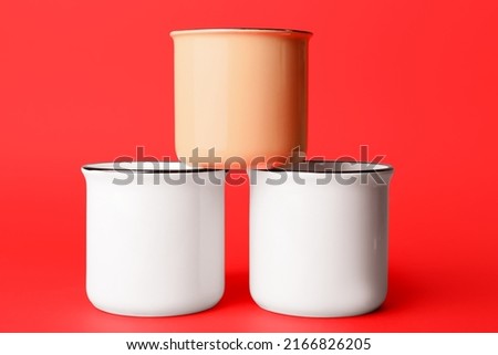 Three cups on red background