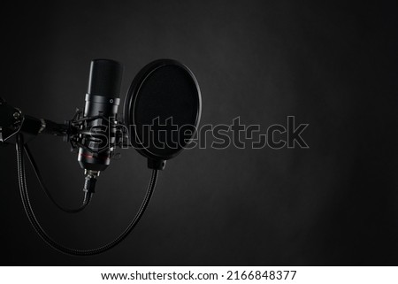 Proffesional studio microphone, isolated on the black background. Podcasts and music recording.