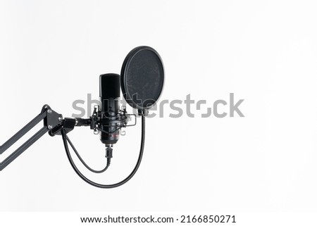Professional studio microphone with pop filter isolated on the white background in radio studio Royalty-Free Stock Photo #2166850271