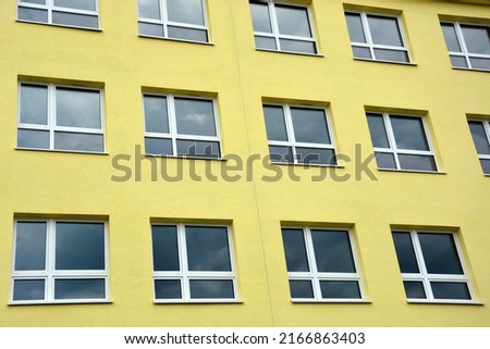 A restored yellow prefabricated school and office block
