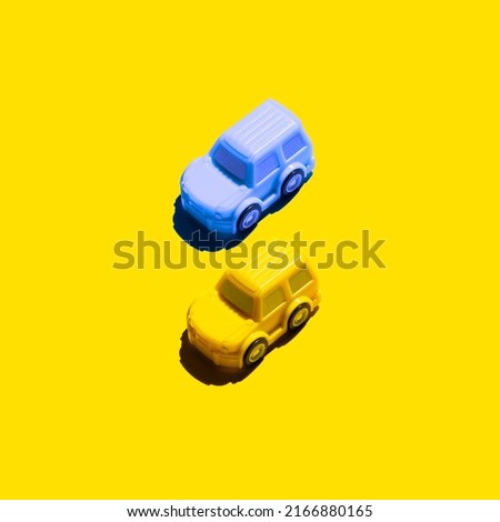 two cars on a yellow background. Concept about Ukraine