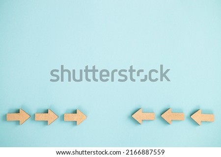 Wooden arrows point to the center on blue background. Space for your text