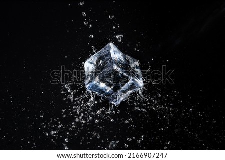 ice cube in water jet on black background Royalty-Free Stock Photo #2166907247
