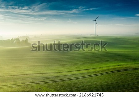 Wonderful foggy green field at sunrise, view from above, Europe Royalty-Free Stock Photo #2166921745