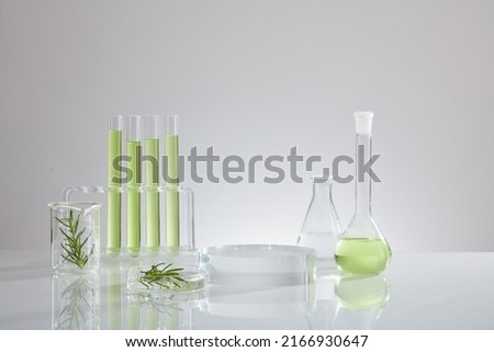 Green liquid extract from green leaf , research for develope decorated with transparent podium with laboratory equipment , chemistry research content Royalty-Free Stock Photo #2166930647
