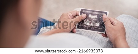 Asian or caucasian pregnant woman holding ultrasound 4d scan image, Expectation of a child and Maternity prenatal care.Parenthood, bonding together, woman pregnancy concept banner