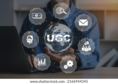 UGC (User-generated Content).Businessman using a computer to "UGC" abbreviation.UGC icon. Royalty-Free Stock Photo #2166944345
