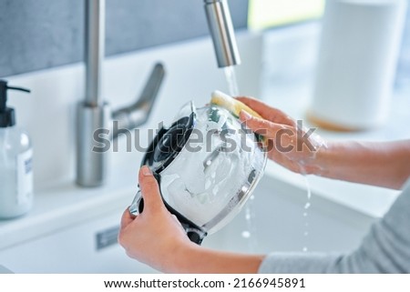 Young woman cleaning coffee pot or machine Royalty-Free Stock Photo #2166945891