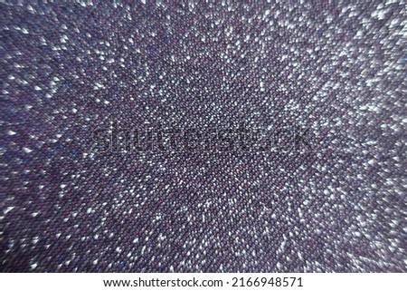 Surface of shiny purple lurex fabric with pink and blue tinges