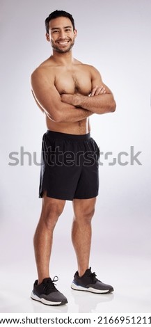 Feeling more confident in my body. Shot of a handsome young man against a studio background. Royalty-Free Stock Photo #2166951211