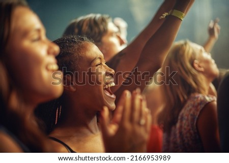Having the time of their lives. Young girls in an audience enjoying their favourite bands performance. Royalty-Free Stock Photo #2166953989