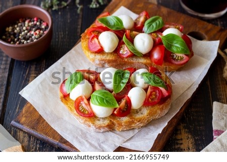 Bruschetta with mozzarella, tomatoes and basil. Vegetarian food. Healthy eating Royalty-Free Stock Photo #2166955749