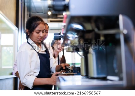 Barista learning make coffee by espresso machine. Group schoolgirl studying hard to learn how to make espresso coffee at barista school. Royalty-Free Stock Photo #2166958567