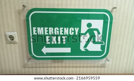 Fire exit sign in the corridor of the building. Emergency Exit