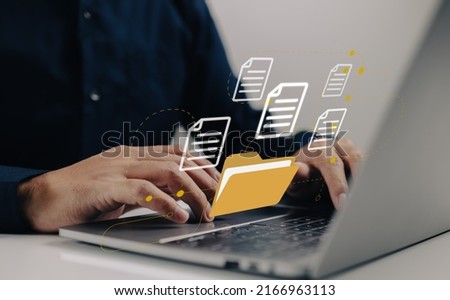 Uploading documents from folder. Open File folder with flying blank documents with laptop computer. Data transfer backup, File Sharing, Document Transferring concept. Royalty-Free Stock Photo #2166963113
