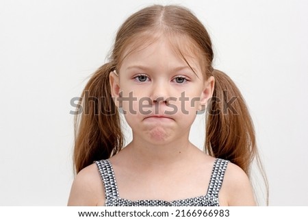 Caucasian little girl of 6 years pursing tense lips which are overly tight and difficult to move. Concept dysarthria, logopedics Royalty-Free Stock Photo #2166966983