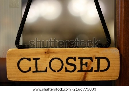 Closed sign of cafe with bokeh white light under concept of business that closed because of Corona Virus Pandemic