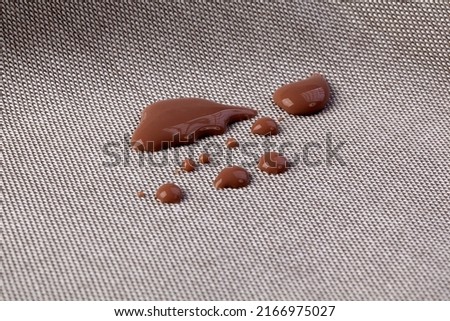 Stains of cocoa milk on the fabric that children may spill on the sofa and you want to clean them with a cleaning solution.