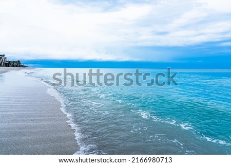 Sunrise in Florida. Calm blue ocean and white sand beach