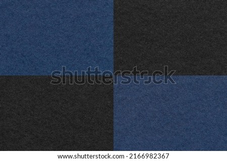 Texture of craft navy blue and black paper background with cells pattern, macro. Structure of vintage dense kraft cardboard. Felt checkered backdrop closeup.