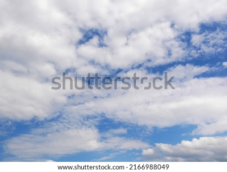 Cirrus and cumulus clouds through which blue sky looks out. Cloudy skies when weather changes.
