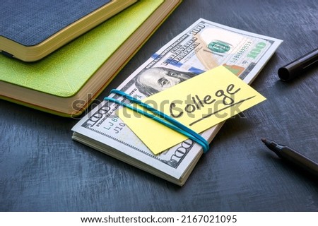 Bundle of money with the inscription college. Tuition payment. Royalty-Free Stock Photo #2167021095