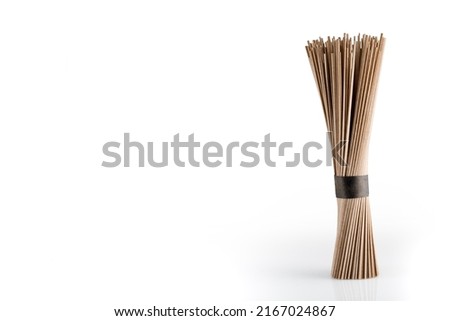 Buckwheat soba noodles in bunche, isolated on white background. Close up. 