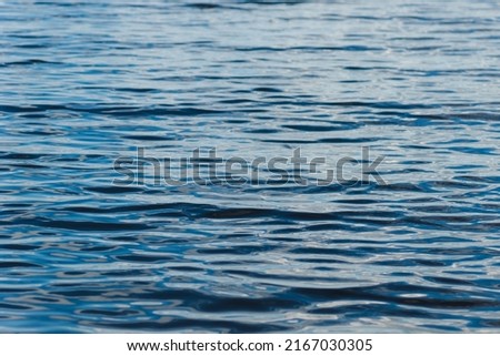 Summer blue wave abstract or natural rippled water texture background. Intense dark blue river, lake or sea water texture