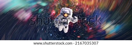 Picture of astronaut spacewalking with glowing stars . Astronaut in outer space. Elements of this image furnished by NASA. Royalty-Free Stock Photo #2167035307