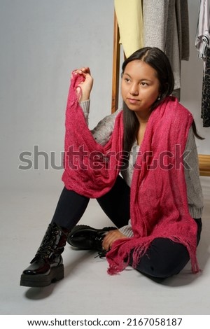 young model posing sitting, young latin girl with black hair, wear casual dress with fuchsia scarf, studio with beauty and youth fashion, lifestyle